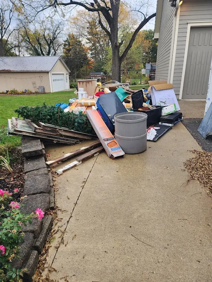 Dumpster being loaded with debris for Roofing Dumpster Rental in Flower Hill